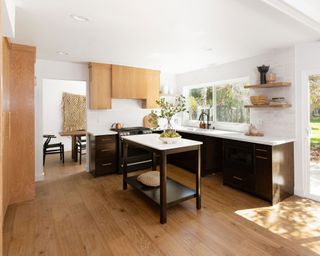Modern kitchen design with wood contrast cabinets and central, freestanding utility island