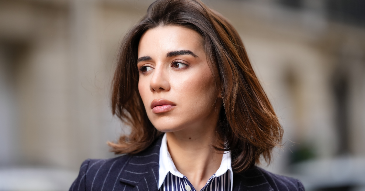Best concealers for dry skin - Katie Degas wears a blue and white striped shirt, a blazer jacket, during a street style fashion photo session, on May 07, 2025 in Paris, France.