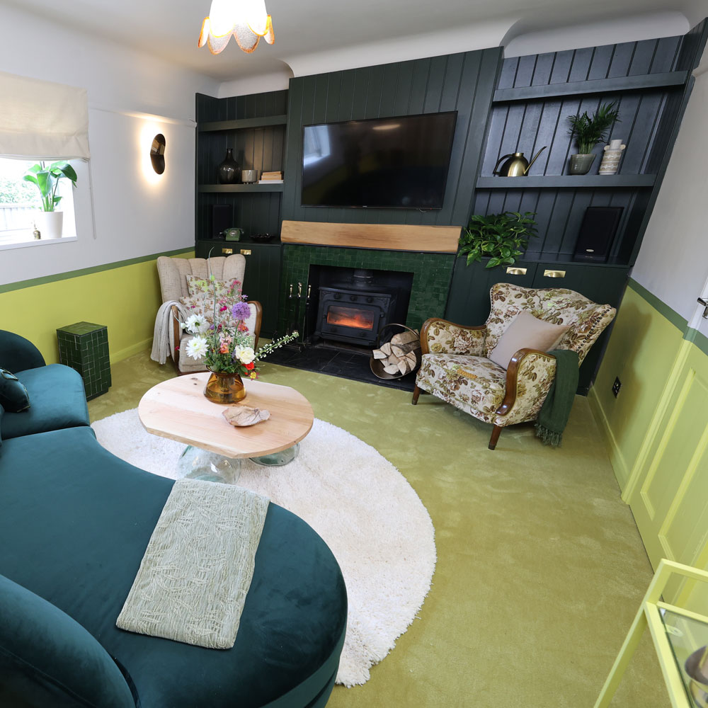 Small living room with dark wood panels and flowery armchairs 