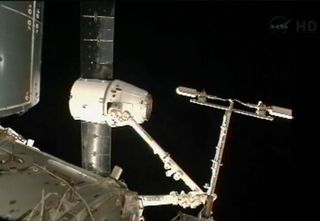 SpaceX's first commercial Dragon spacecraft is captured by a robotic arm on the International Space Station on Oct. 10, 2012.
