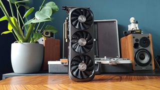 Nvidia GeForce RTX 4070 Super standing vertically on woodgrain table