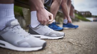 two people putting on shoes