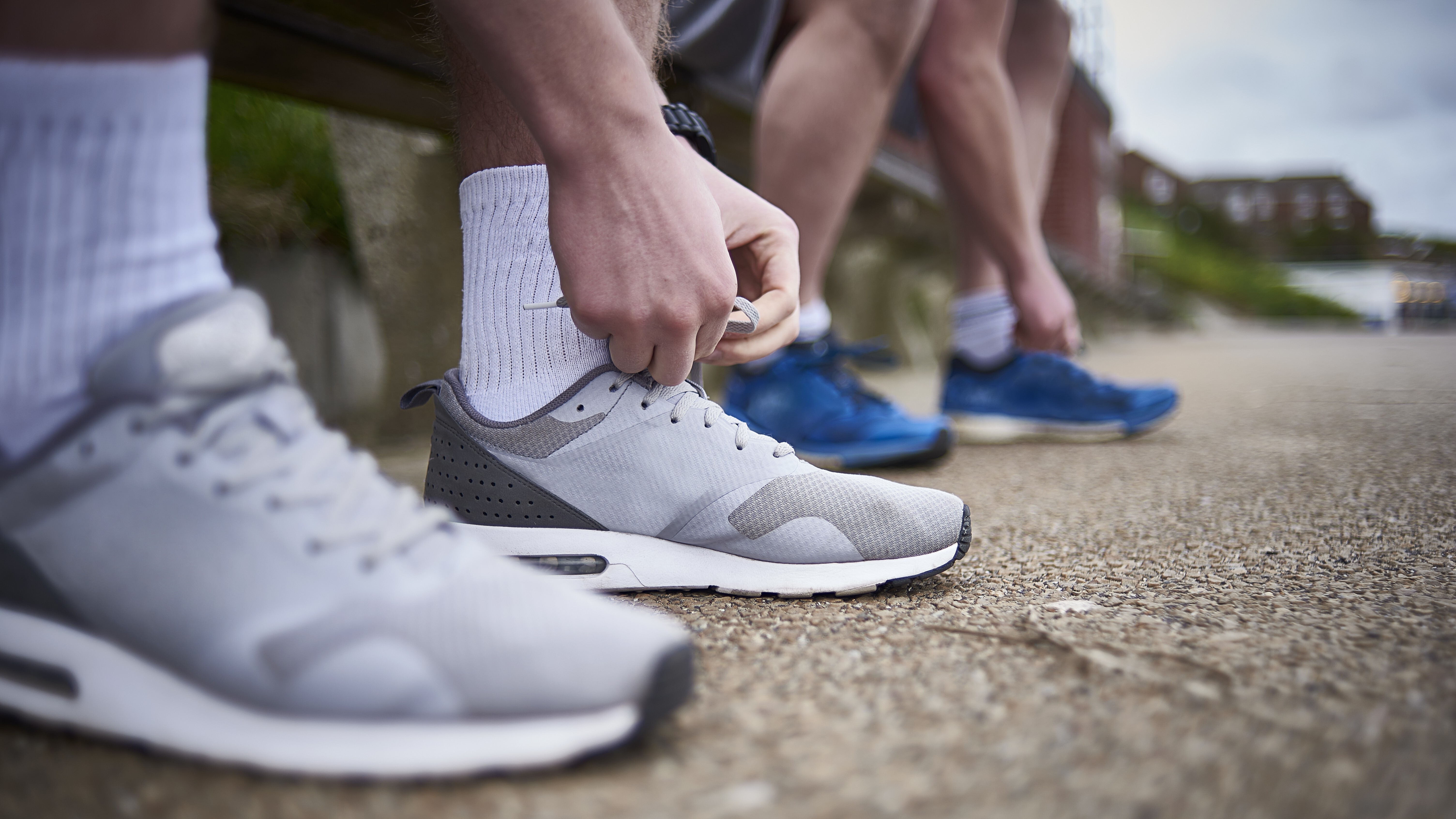 two people putting on shoes