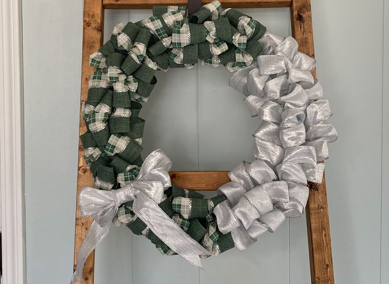 Green and silver/gold ribbon bubble wreath on display on hanger