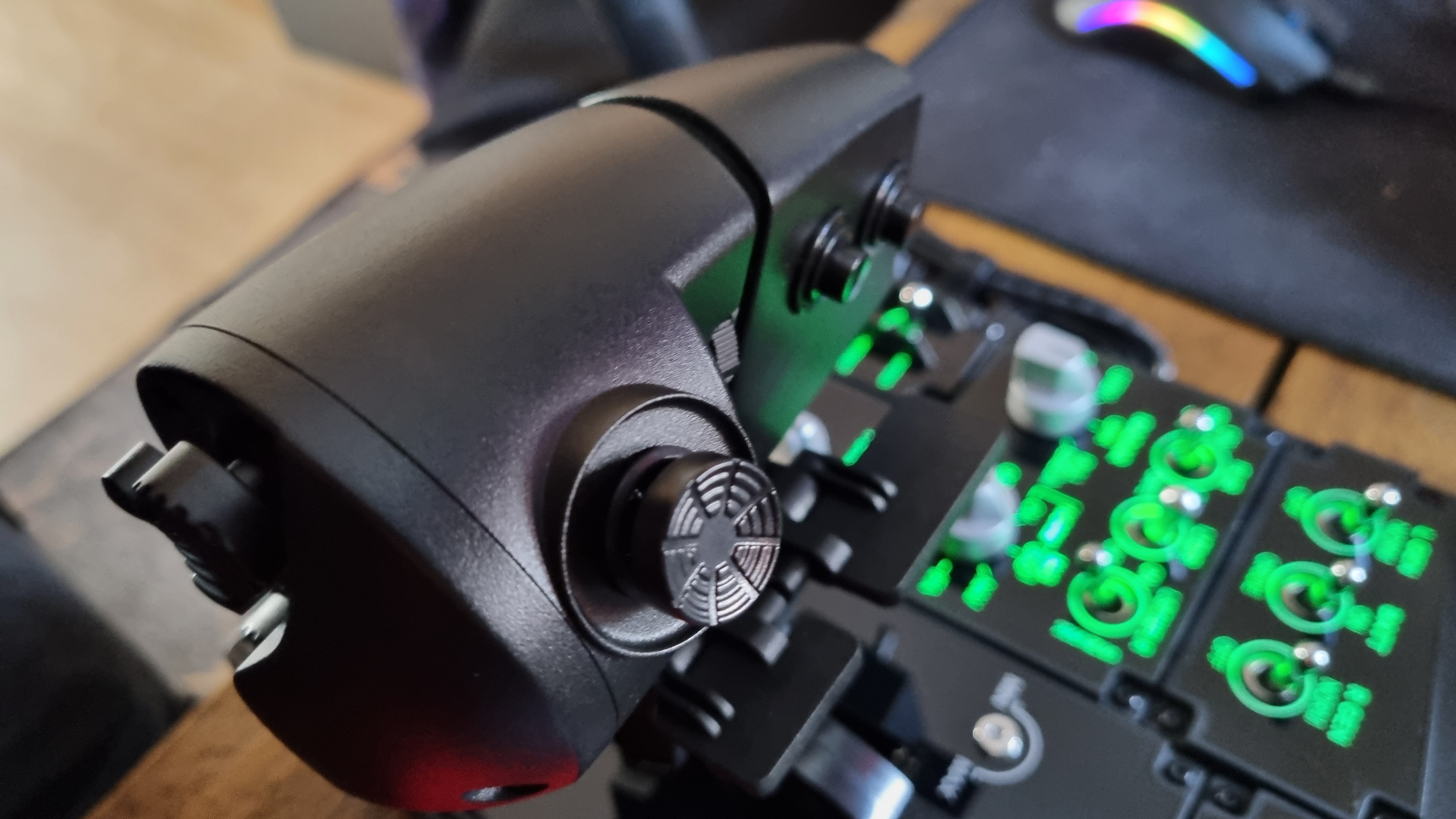 The various controls of the Moza MTP Throttle flight sim controller, lit up in green
