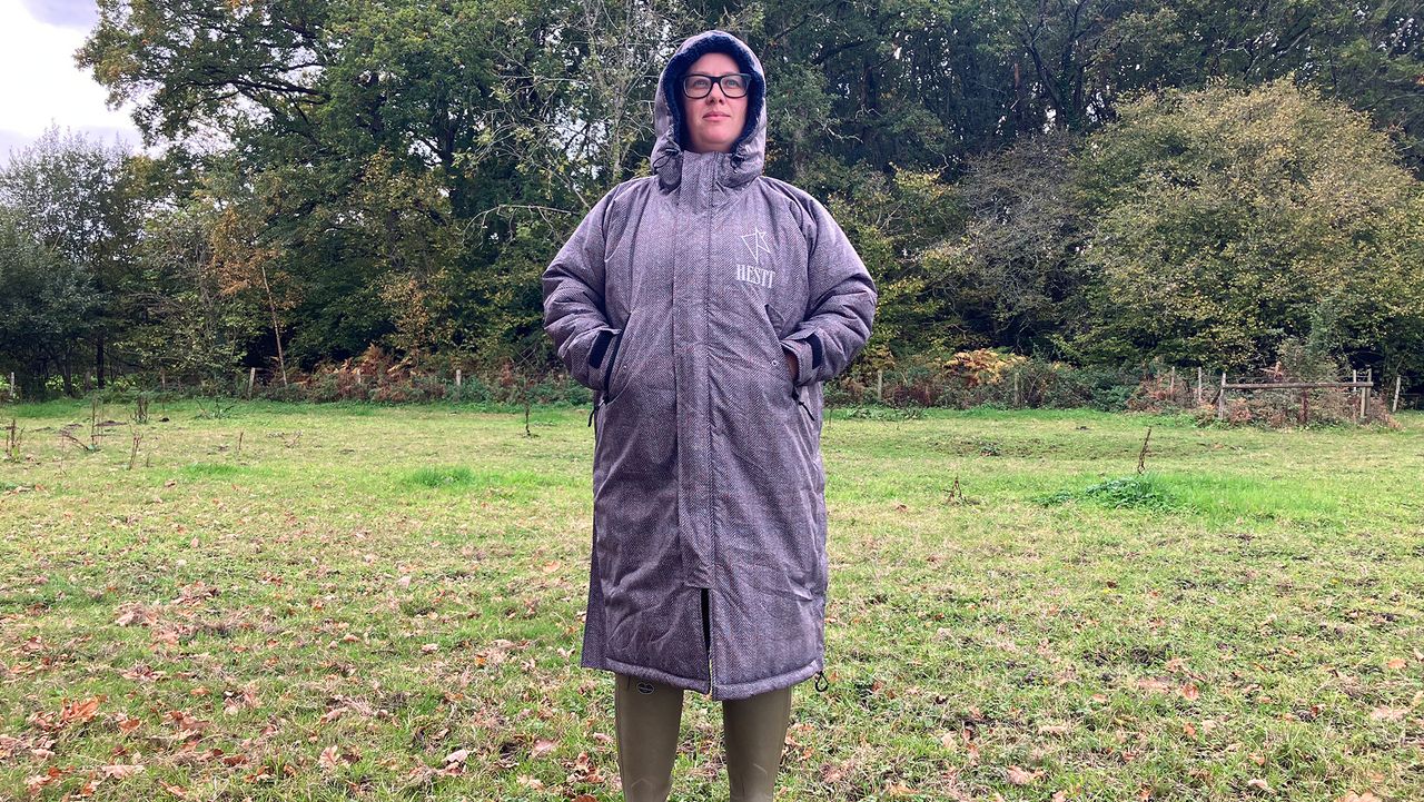 Lady wearing Hestt Eco-Ultra Riding Robe with hood up front view