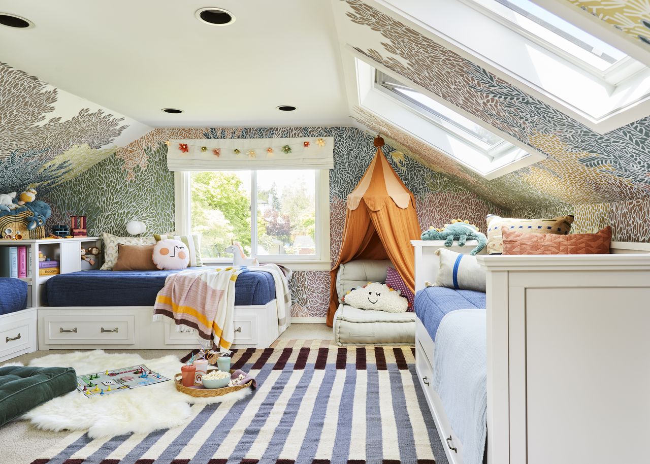 A kids&#039; bedroom with striper patterned rug, skylight and play den