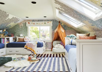 A kids' bedroom with striper patterned rug, skylight and play den