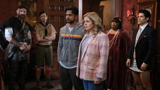 Jay (Utkarsh Ambudkar) and Sam (Rose McIver) flanked by some of the ghost cast in Ghosts US season 3