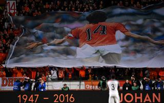 Dutch fans pay tribute to Johan Cruyff following his death by raising a huge banner at the Amsterdam ArenA, later renamed in his honour, ahead of a game between the Netherlands and France in March 2016.