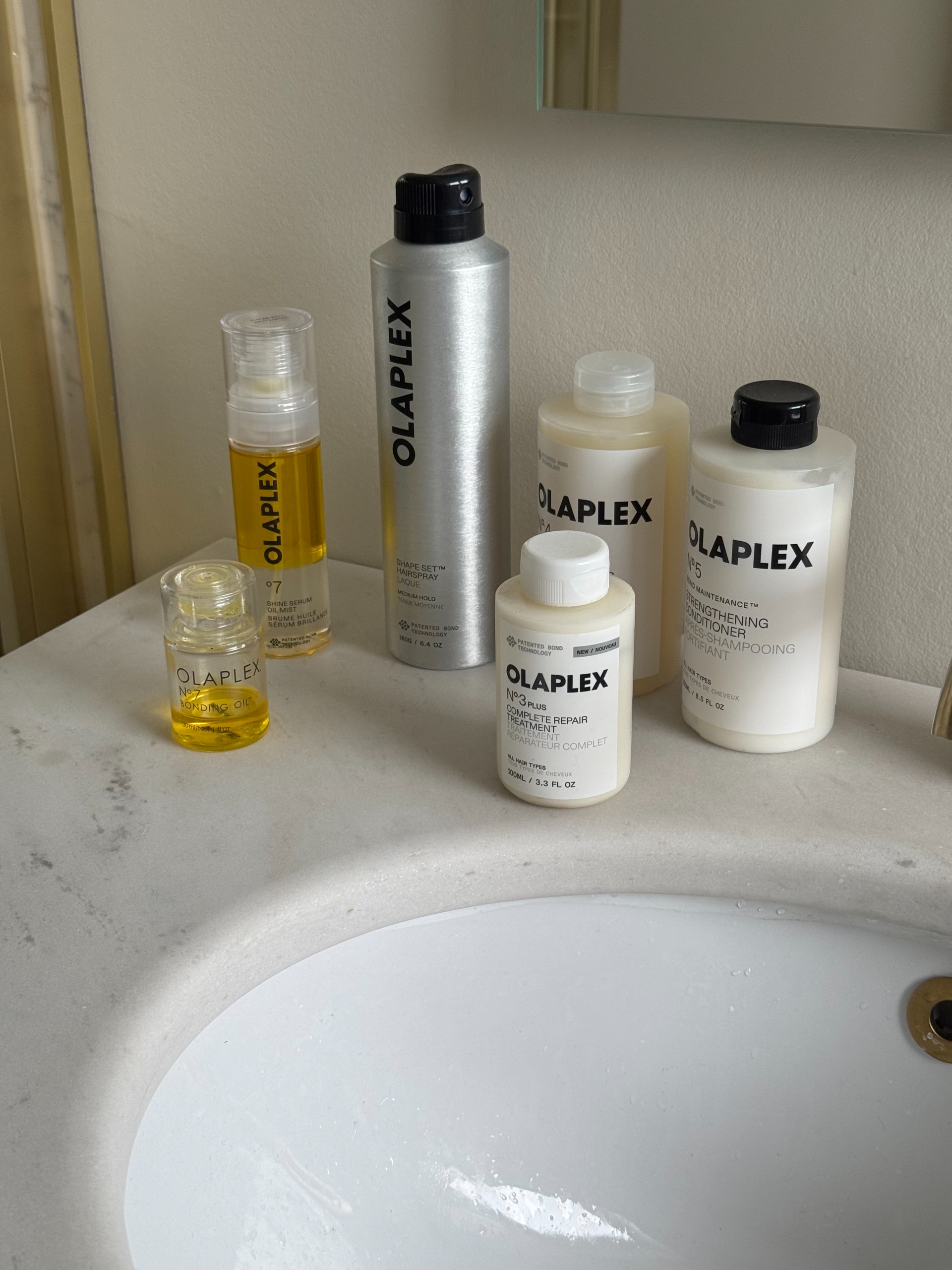 Eleanor's full olaplex hair care routine on a marble sink