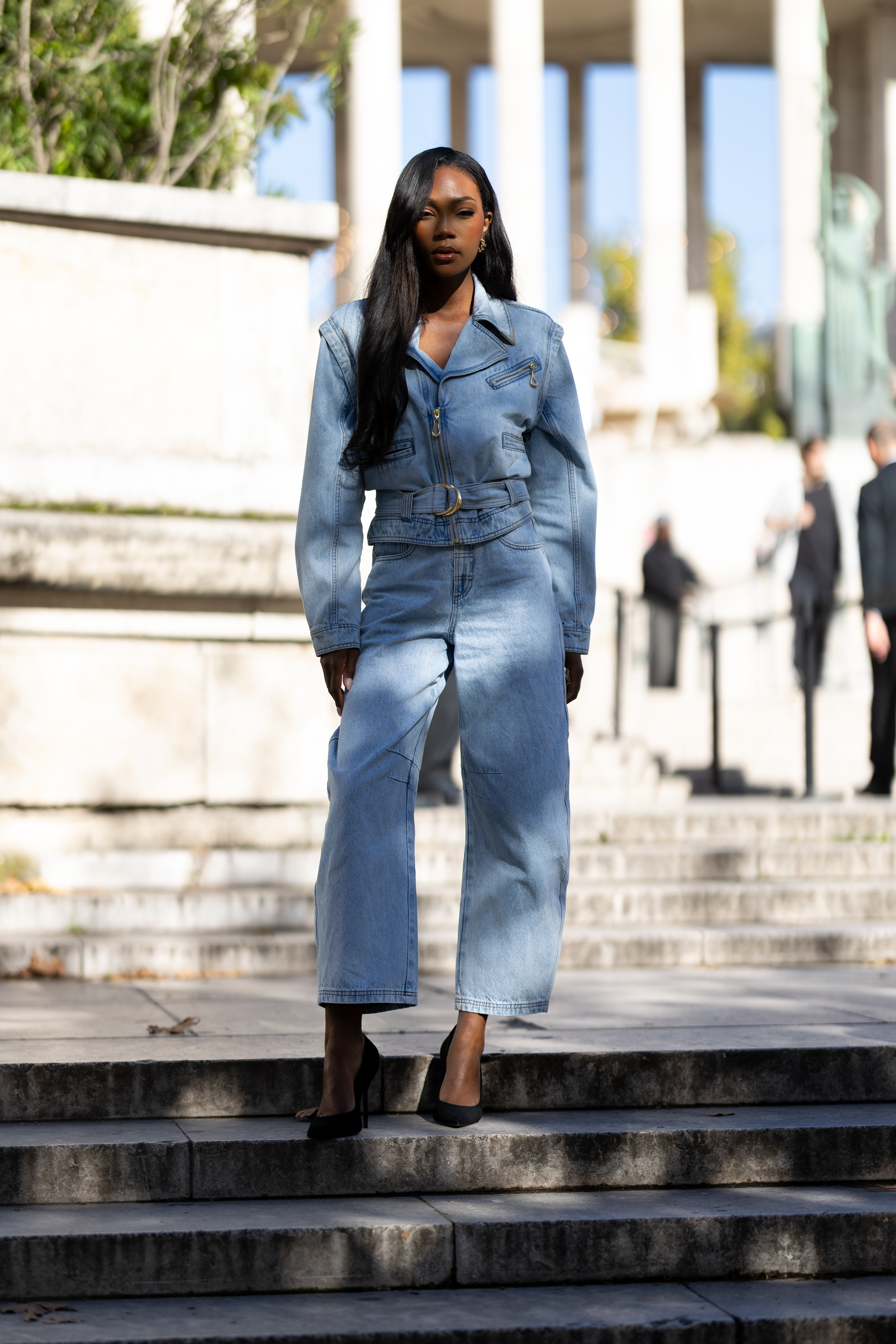 Person wearing a denim jacket during Paris Fashion Week.