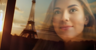 A screenshot from an AI-generated film showing the Eiffel Tower and a girl's face