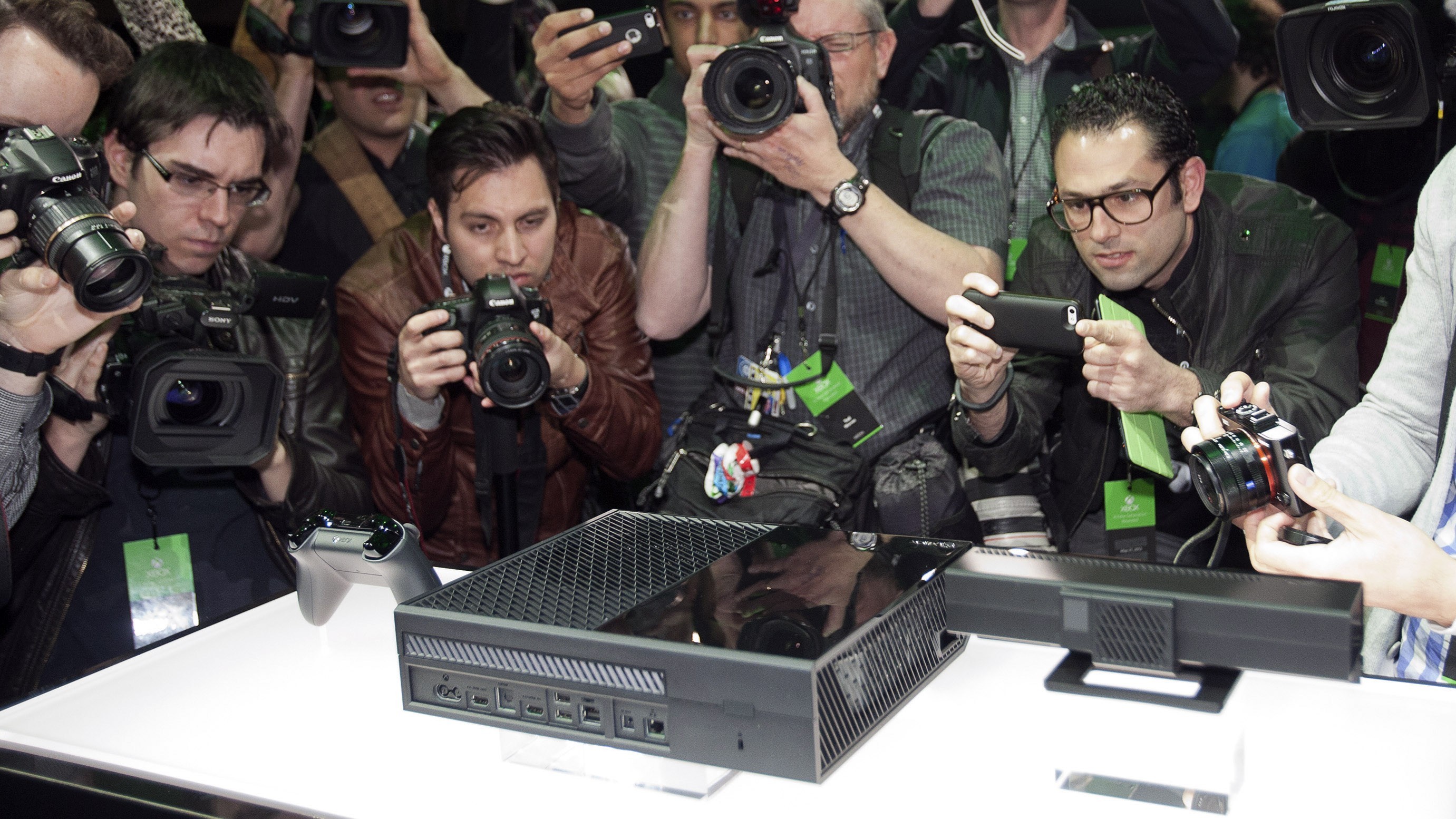 Members of the media take photos and shoot video at the unveiling for Microsoft Corp.'s first new Xbox in almost eight years in Redmond, Washington, U.S., on Tuesday, May 21, 2013.