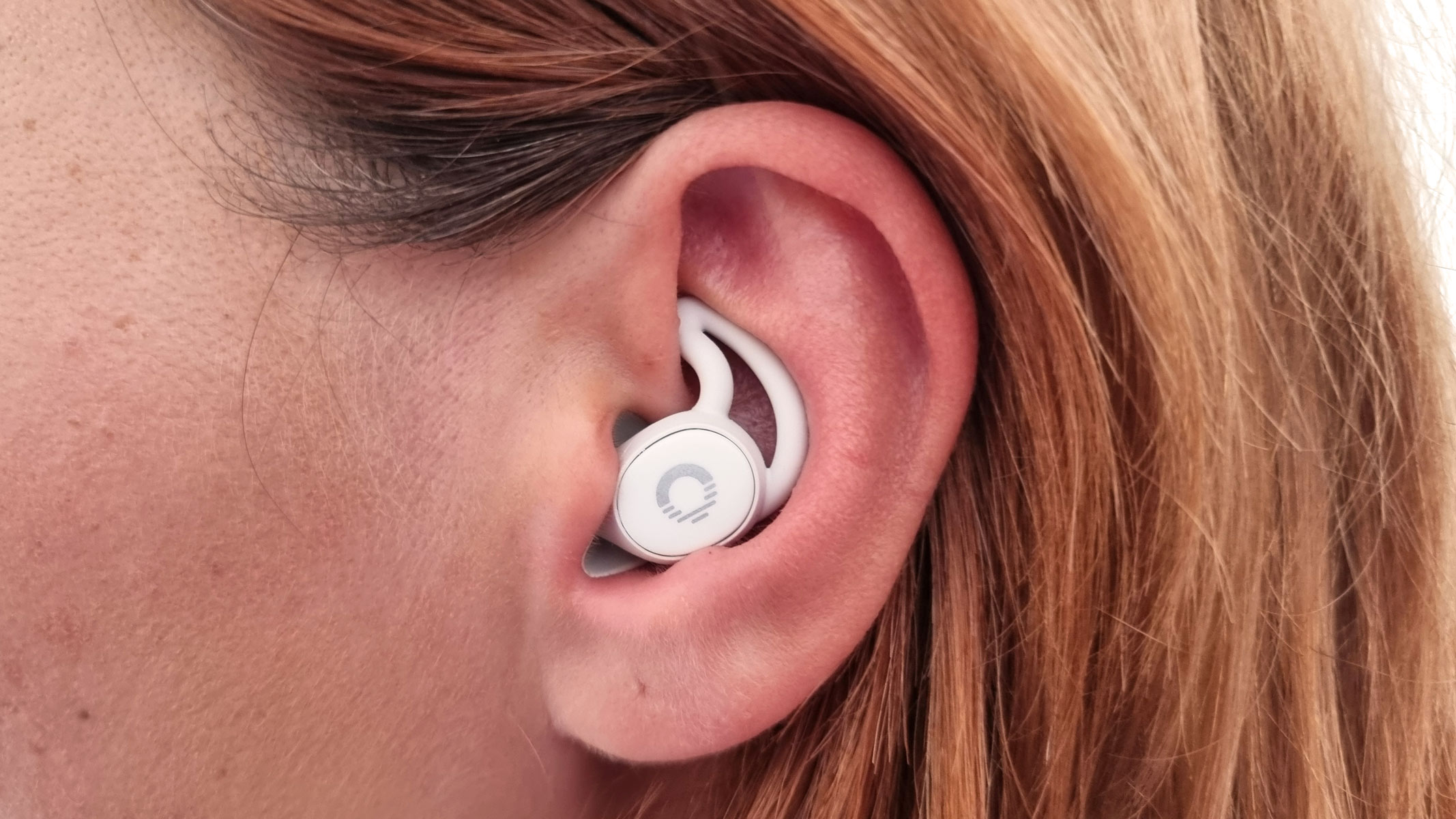 A close-up picture of our reviewer testing the Ozlo Sleepbuds