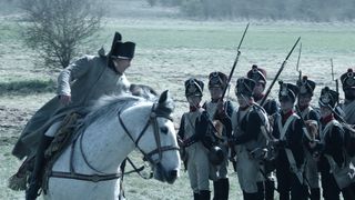 Napoleon VFX; a man rides a horse down a line of soldiers