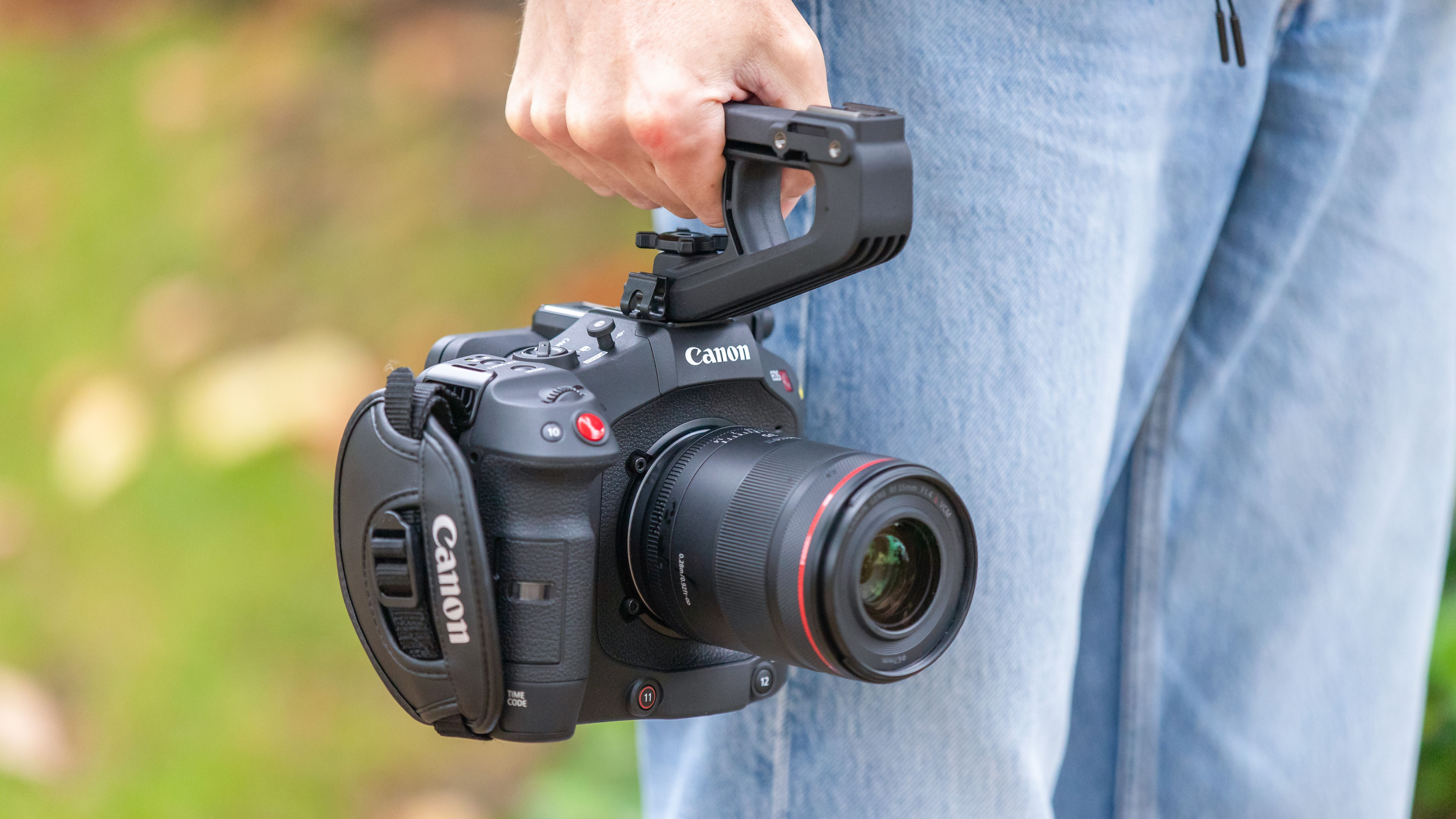 Person holding a Canon EOS C80 cinema camera outside