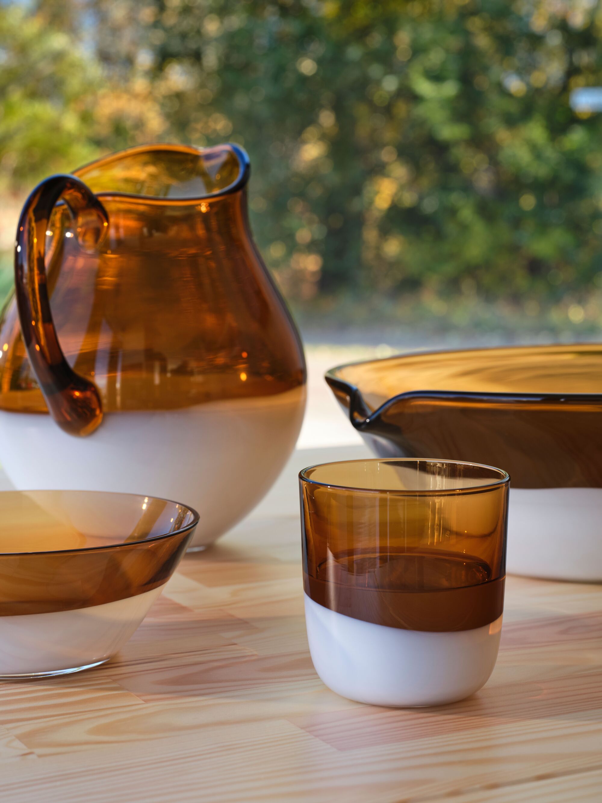 Close-up image of amber glass serve-ware where the bottom half is opaque white glass.