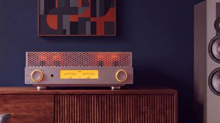 FiiO EA13 valve amplifier in silver on a wooden cabinet