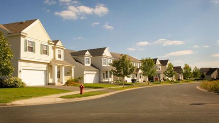 A row of suburban American homes in the sun