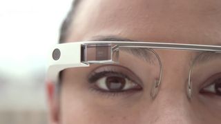 close up of woman's eye with Google Glass above it