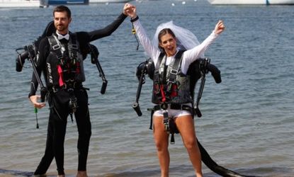 Grant Engler and his new wife Amanda celebrate after their wedding ceremony to which they arrived via jet pack suits over the Newport Beach, Calif., harbor.