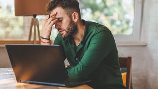 Person using a Windows 11 laptop looking annoyed