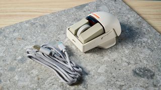 The Lofree Touch mouse on a stone surface