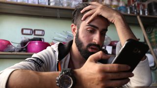 Man looking at smartphone.