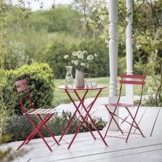 budget garden idea with red bistro set, white/grey decking, garden view 