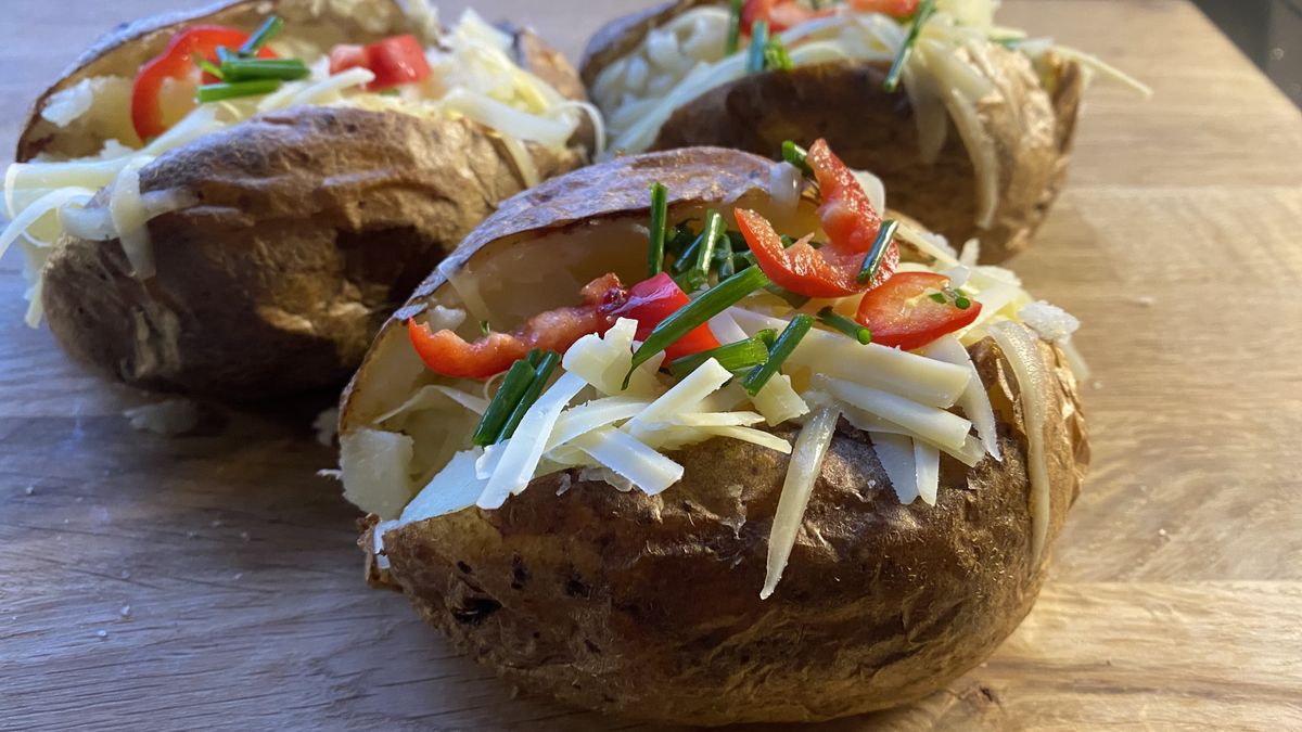 Air fryer baked potato on a chopping board