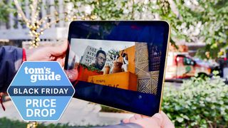 10th generation iPad being held with a black friday price drop badge