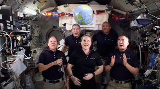 Five Expedition 64 astronauts on the International Space Station celebrate 2021 by ringing in the New Year with a zero gravity ball drop. They are (clockwise from top left): NASA astronauts Mike Hopkins, Victor Glover, Japan Aerospace Exploration Agency astronaut Soichi Noguchi and NASA astronauts Kate Rubins and Shannon Walker.