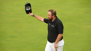 Shane Lowry of Ireland acknowledges the crowd on the 18th green during the third round of the 148th Open Championship held on the Dunluce Links at Royal Portrush Golf Club