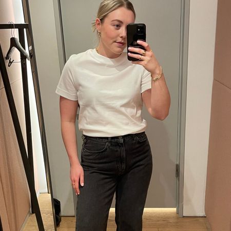 Woman wears white t-shirt and black jeans