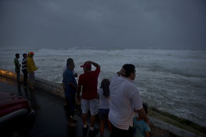 People in Cabo San Lucas watch the waves during Hurricane Odile in 2014.