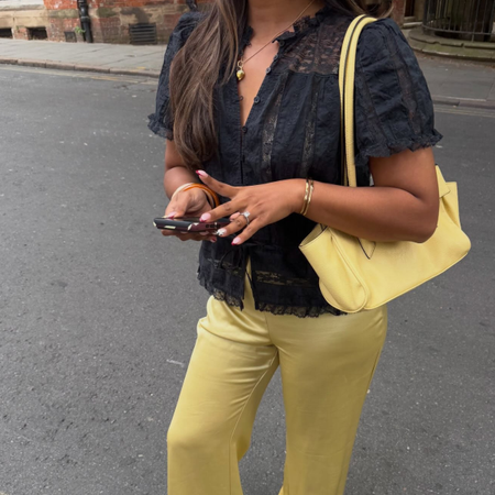 An image of a woman wearing non jeans fall outfit idea 2026