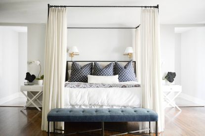 A canopy bed with curtains around it