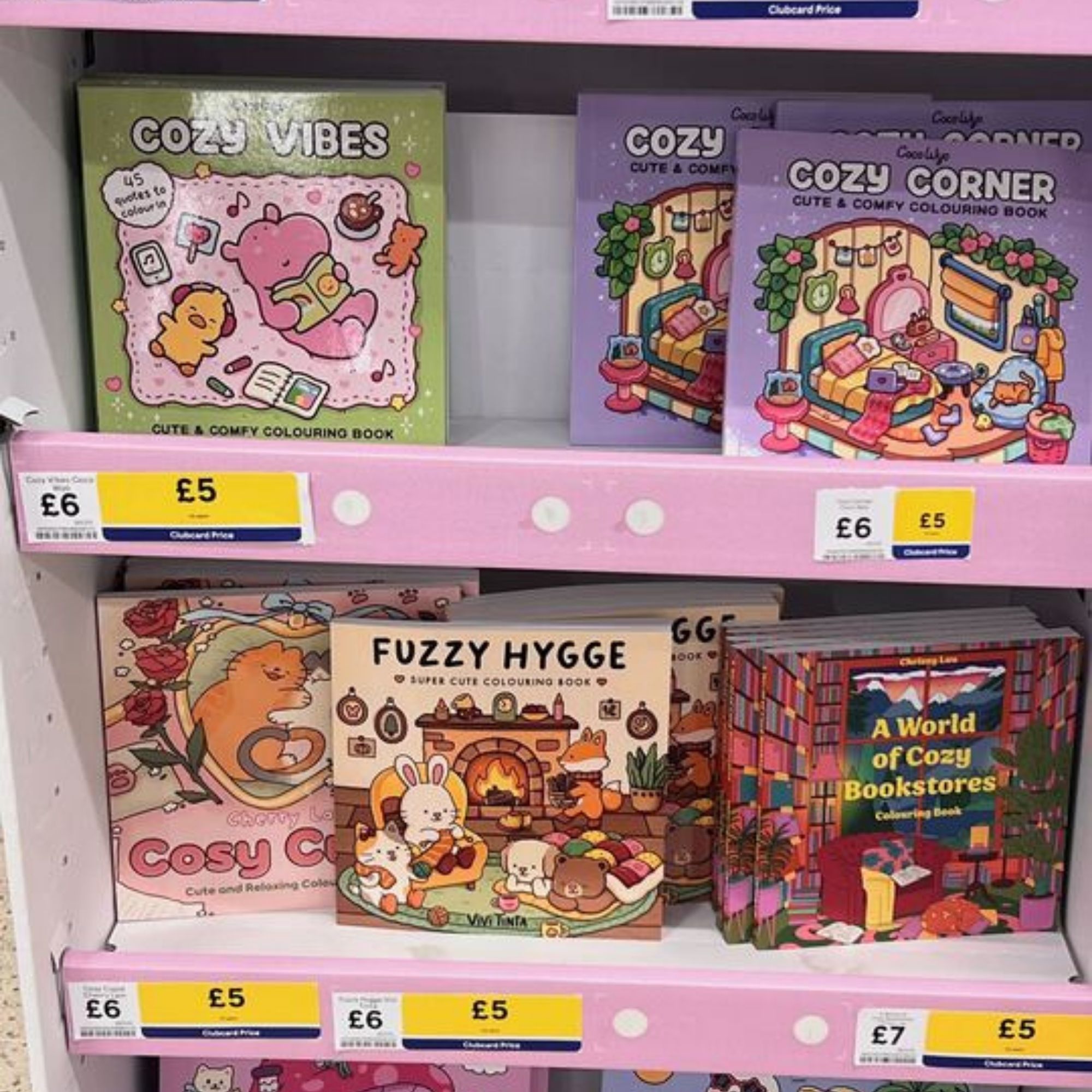 A Tesco shelf displaying a variety of colouring books, including the Fuzzy Hygge range.