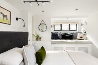 Interior Fox basement bedroom with white built-in seating under the small window