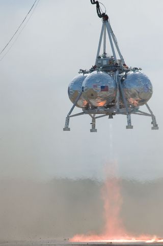 NASA's Morpheus lander in flight during its fourth tethered test at the Johnson Space Center in Houston.