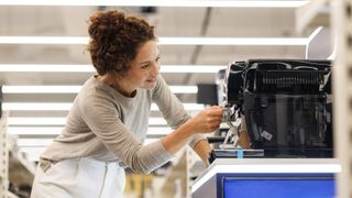Woman looking at coffee machines in store