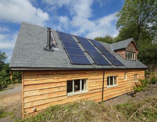 solar panels on roof of timber clad house