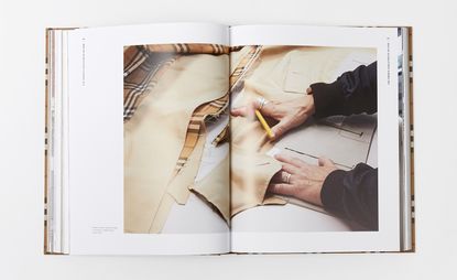 Burberry fashion books spread with person on open page creating a trench coat
