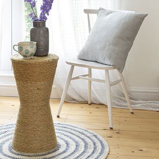 living room white walls wooden flooring cushion with table and flower vase with wooden table