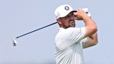 Bryson DeChambeau plays an iron shot