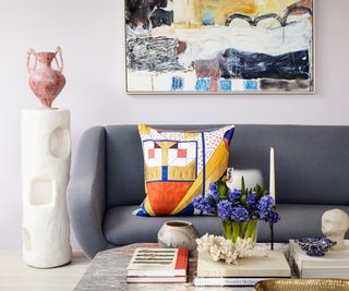 grey sofa, pale lavender walls and bright wall art