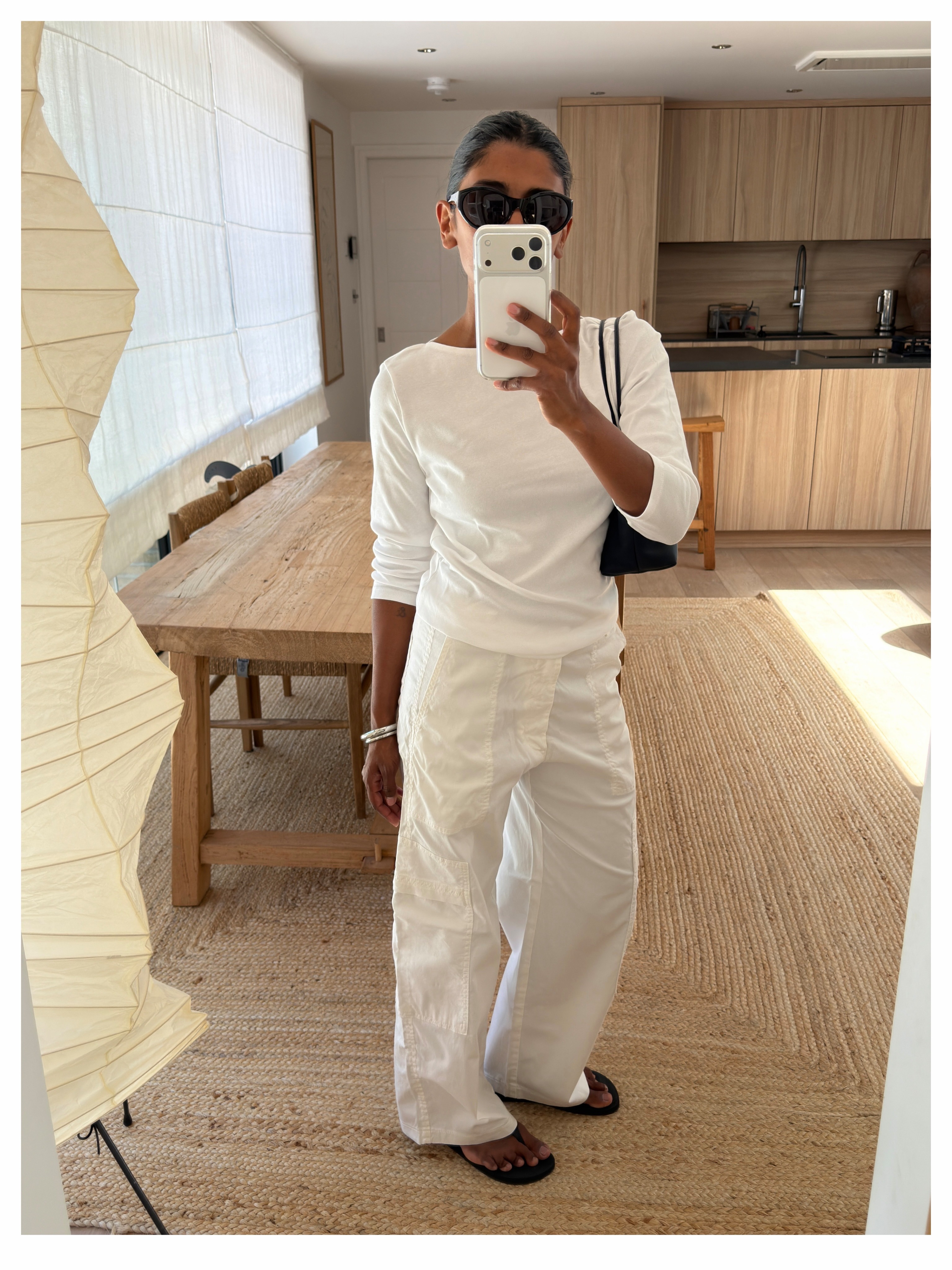 Woman in a white long sleeve tee and sweatpants.