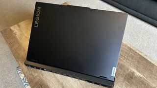 Lenovo Legion Pro 7i gaming laptop lid open on a wooden table