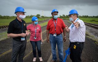 Leaders on the James Webb Space Telescope launch confer as the rocket rolls out to the launch pad. From left, NASA James Webb Space Telescope Program Scientist Eric James, NASA James Webb Space Telescope Program Manager Jeanne Davis, NASA Program Director for the James Webb Space Telescope Greg Robinson, and Arianespace’s Vice President for French Guiana Bruno Gérard.